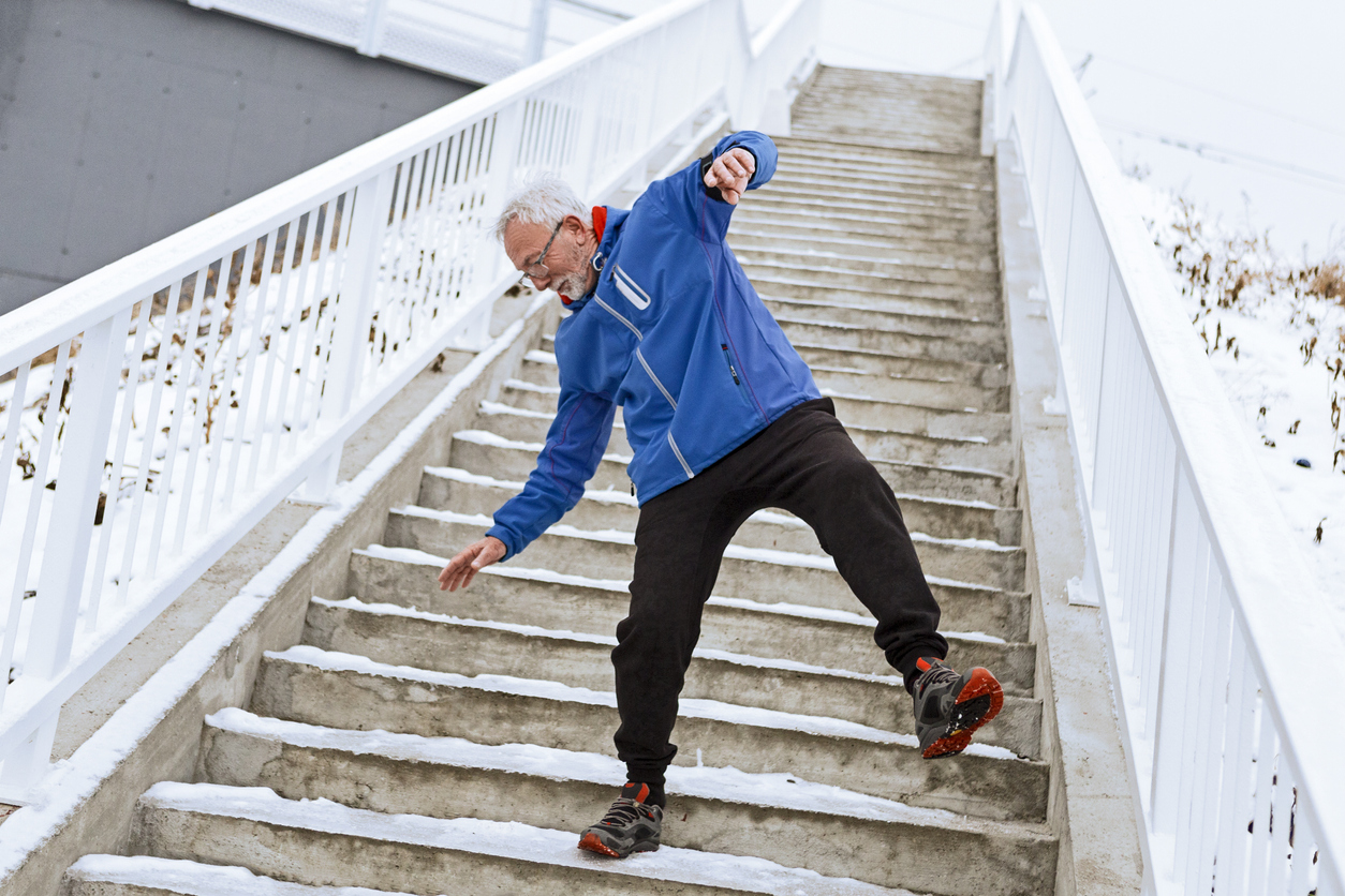 man about to slip on icey steps