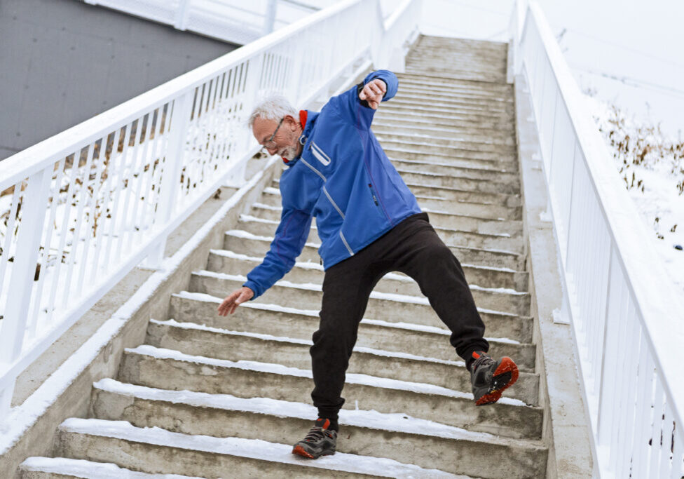 man about to slip on icey steps